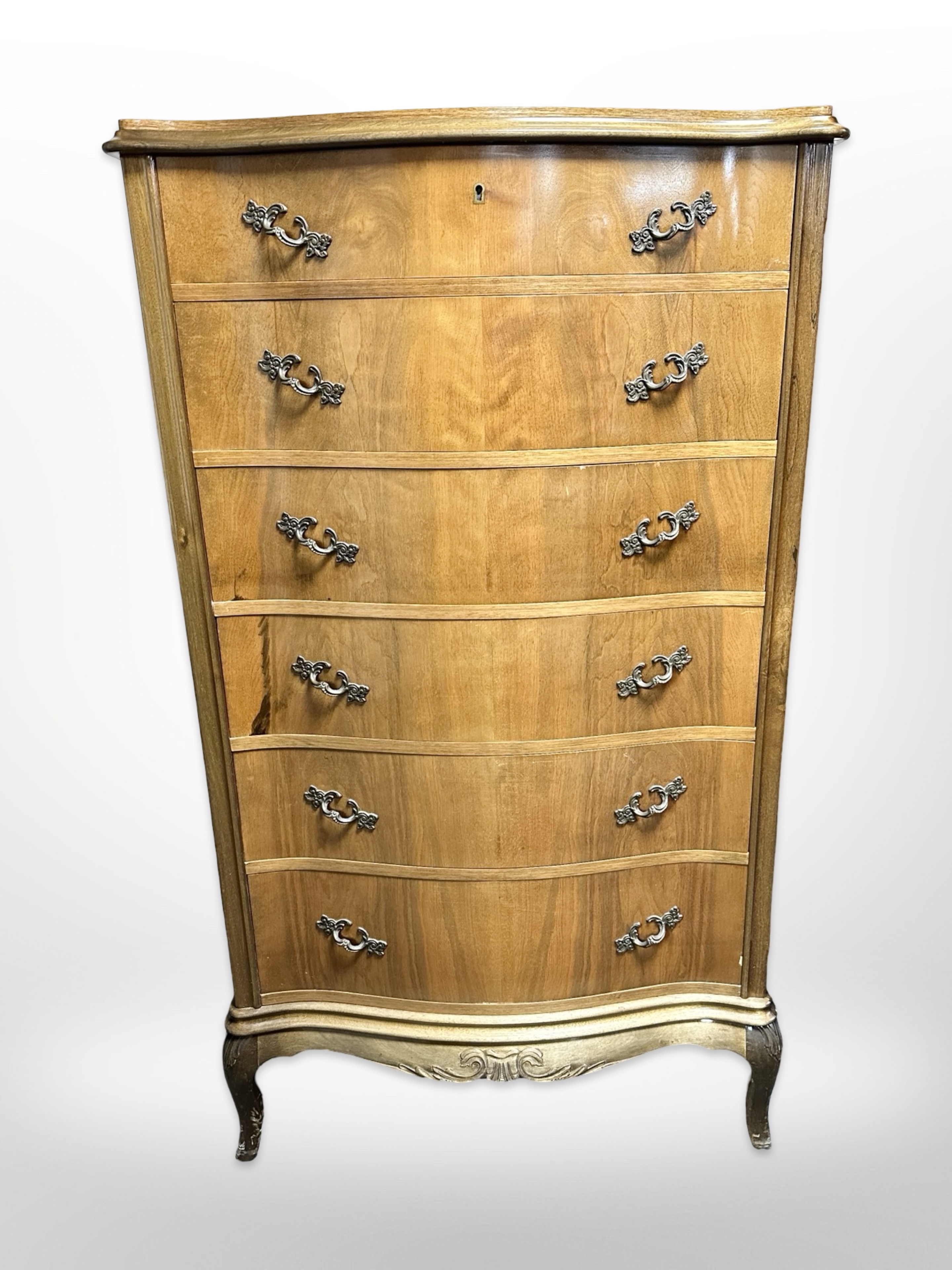 A 20th century Continental walnut serpentine fronted six drawer tall boy,
