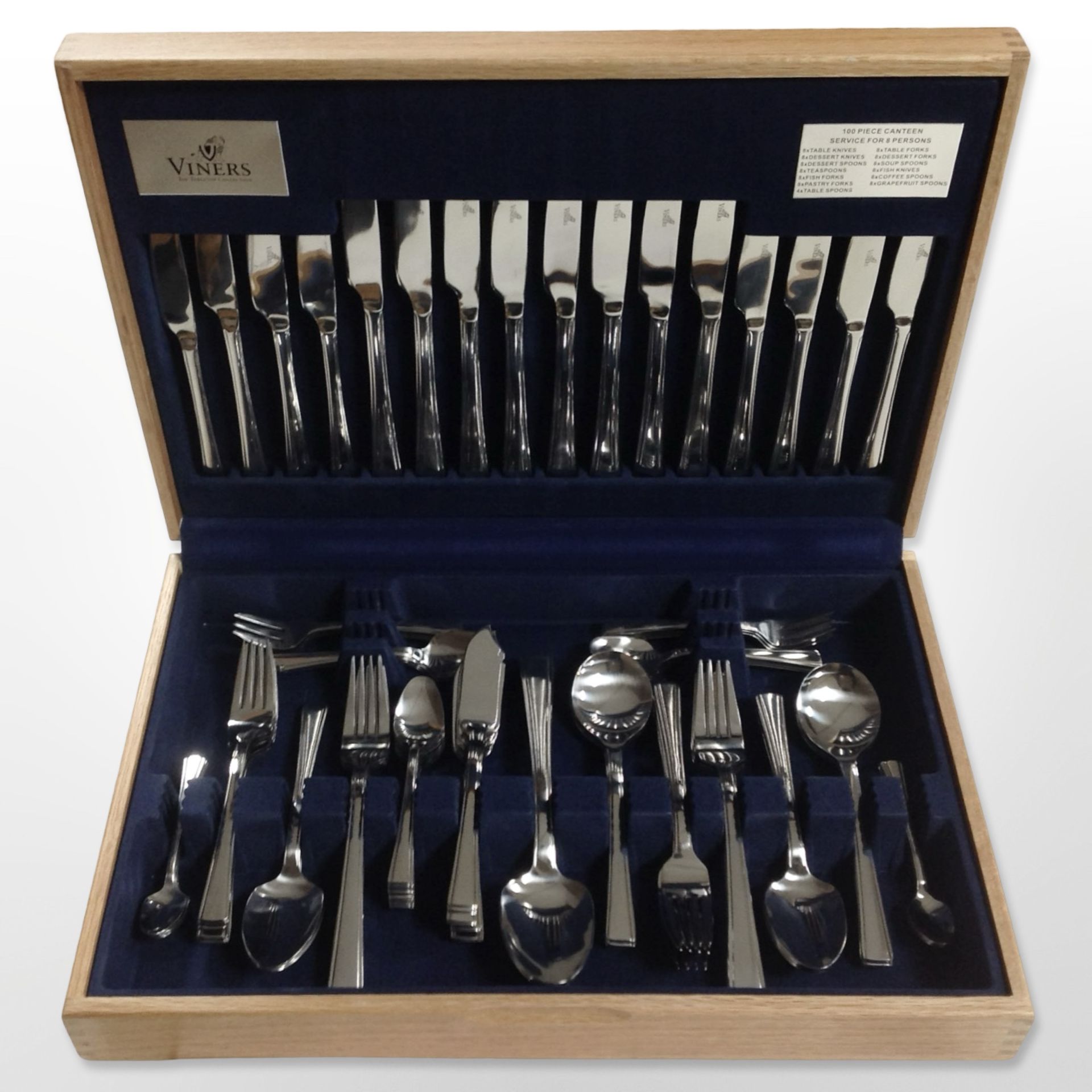 An oak-cased canteen of Viners stainless steel cutlery.