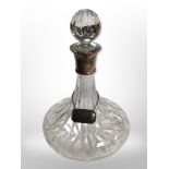 A modern crystal ship's decanter with silver collar and decanter label, height 28cm.