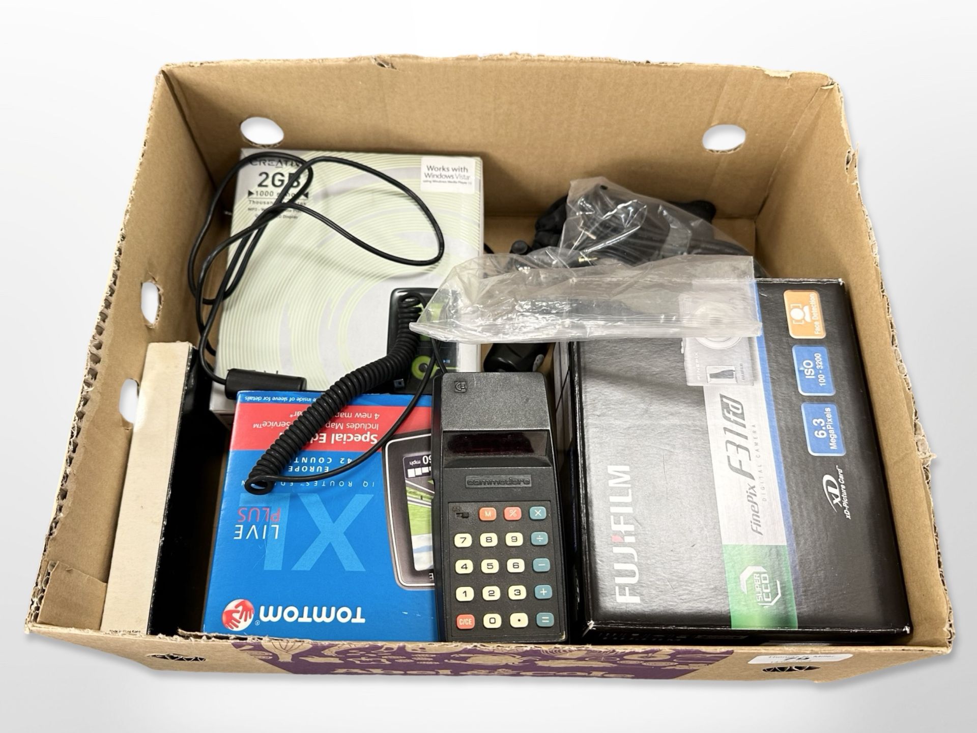 A Fujifilm digital camera, Commodore electric calculator, Tomtom Sat-Nav, an MP3 player.