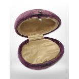 An antique ovoid purple velvet jewellery box.