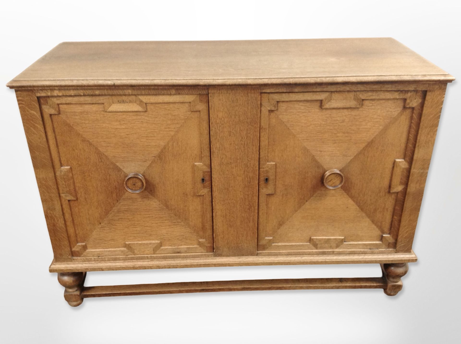 A 20th century panelled oak double door sideboard,