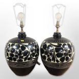 A large pair of ceramic bulbous table lamps,