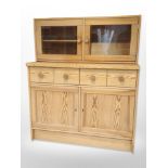 A contemporary pine sideboard with glazed cabinet above,