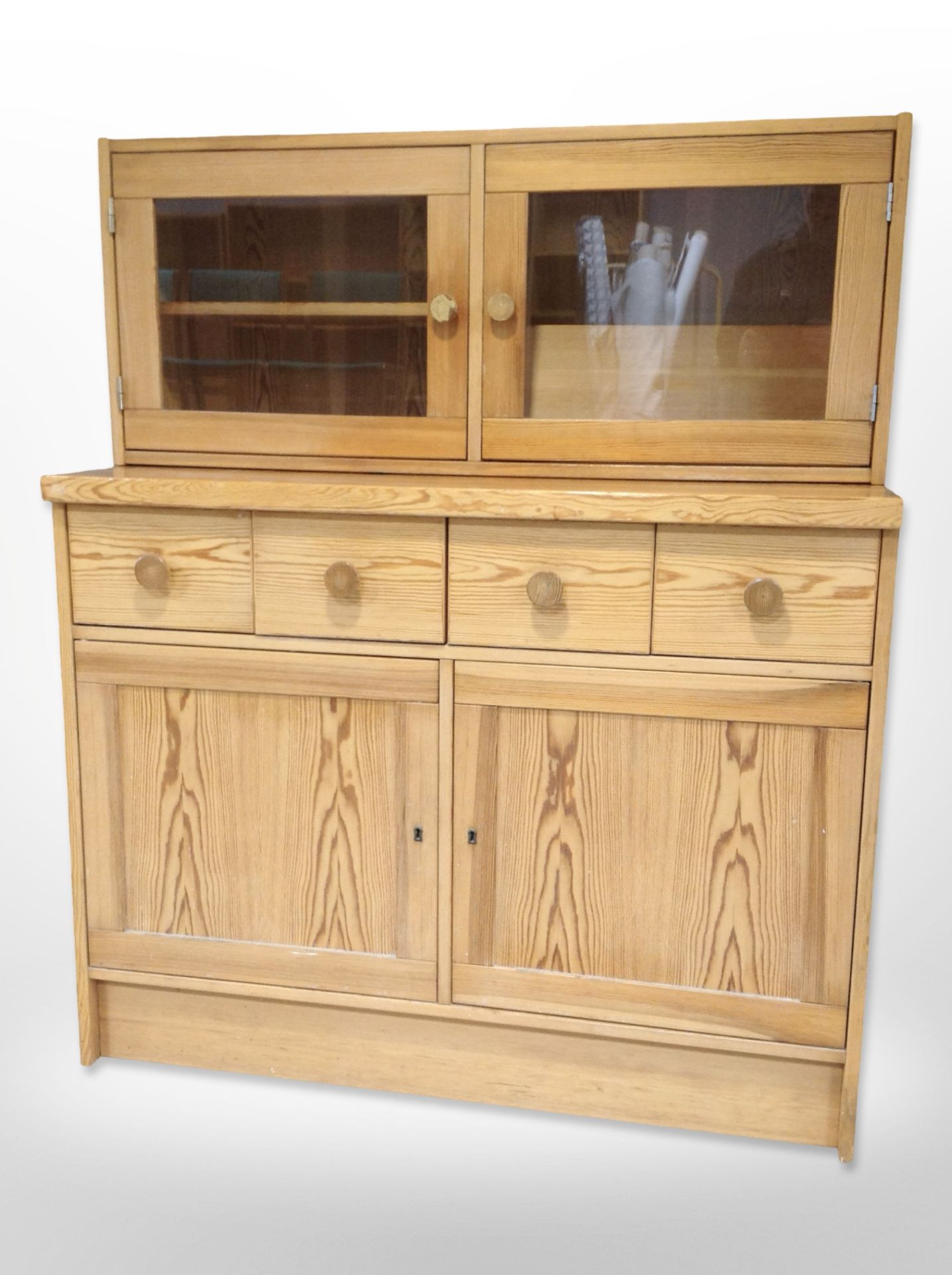 A contemporary pine sideboard with glazed cabinet above,