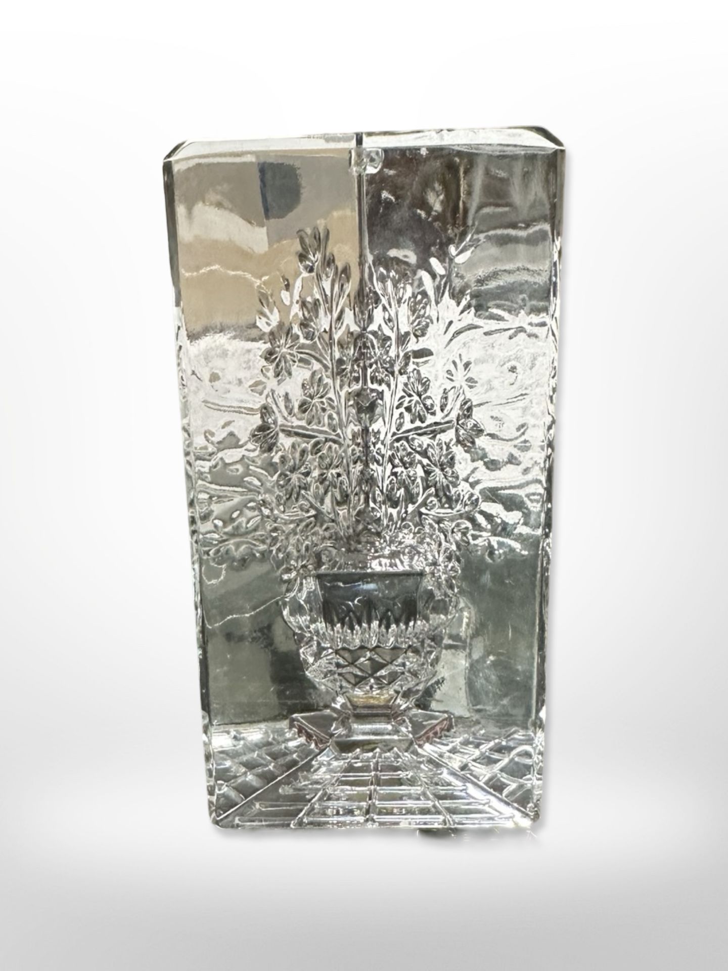 A Waterford crystal paperweight depicting flowers in a pot, height 11.5cm.