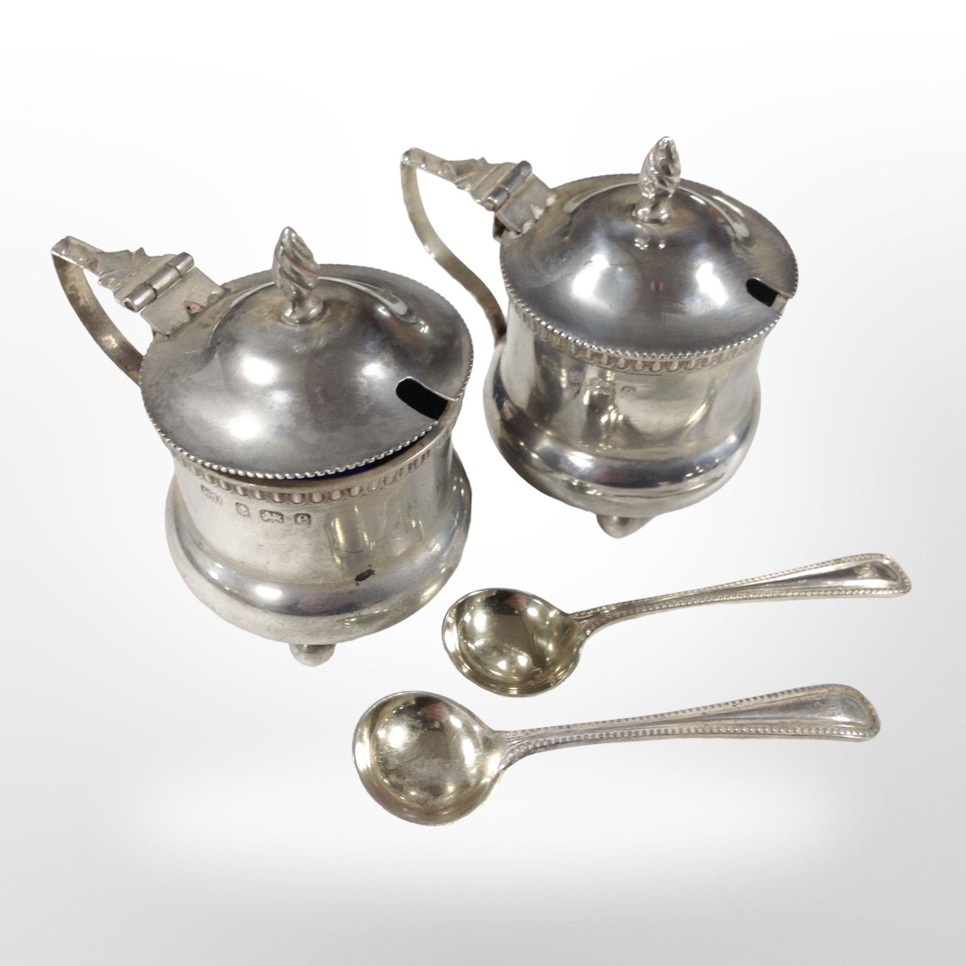 A pair of silver mustard pots with blue-glass liners, Birmingham marks,