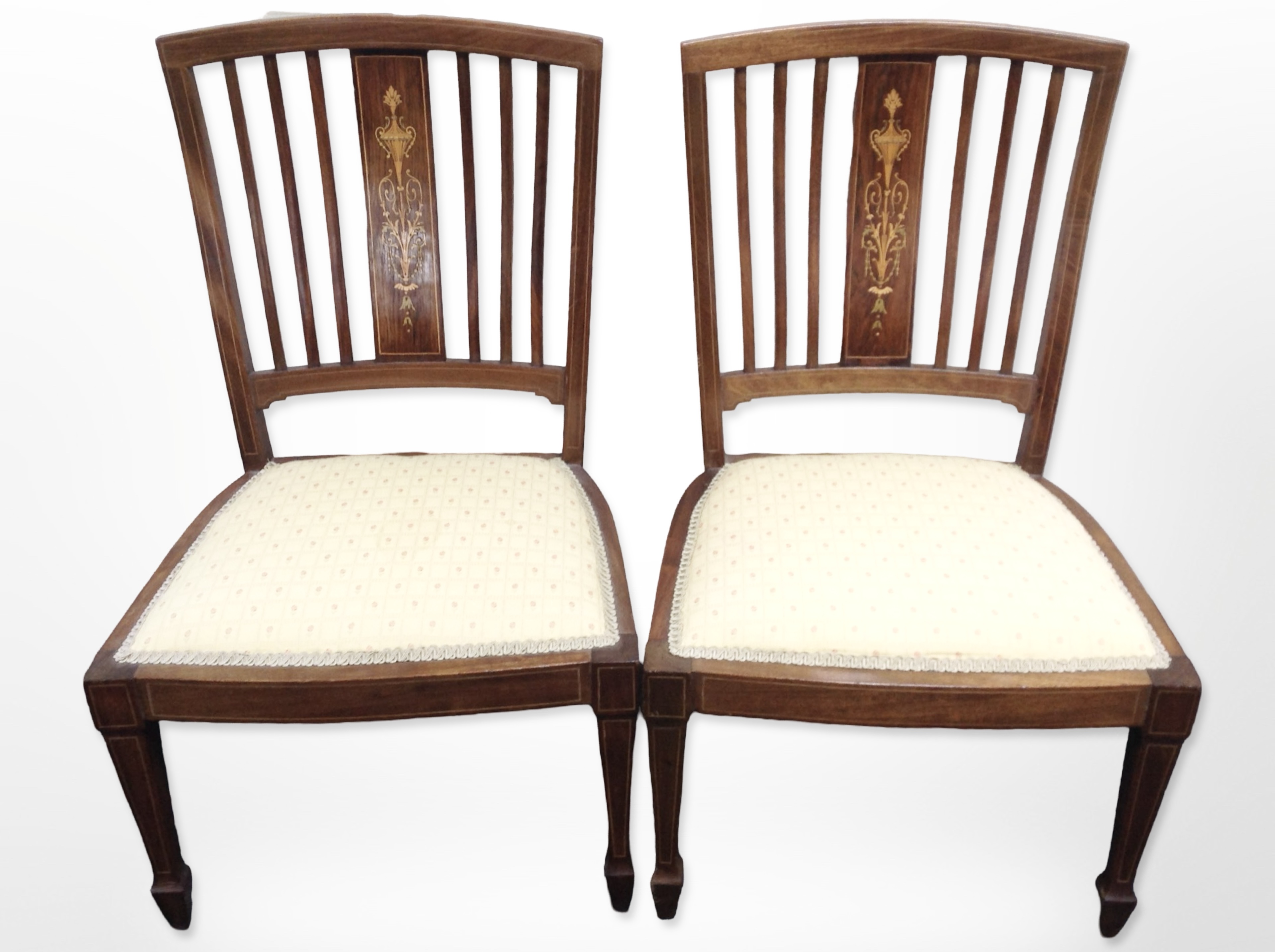 A pair of Edwardian mahogany and satinwood marquetry inlaid occasional chairs