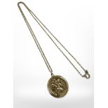 A 9ct yellow gold St Christopher disc pendant on 9ct gold chain CONDITION REPORT: 7.