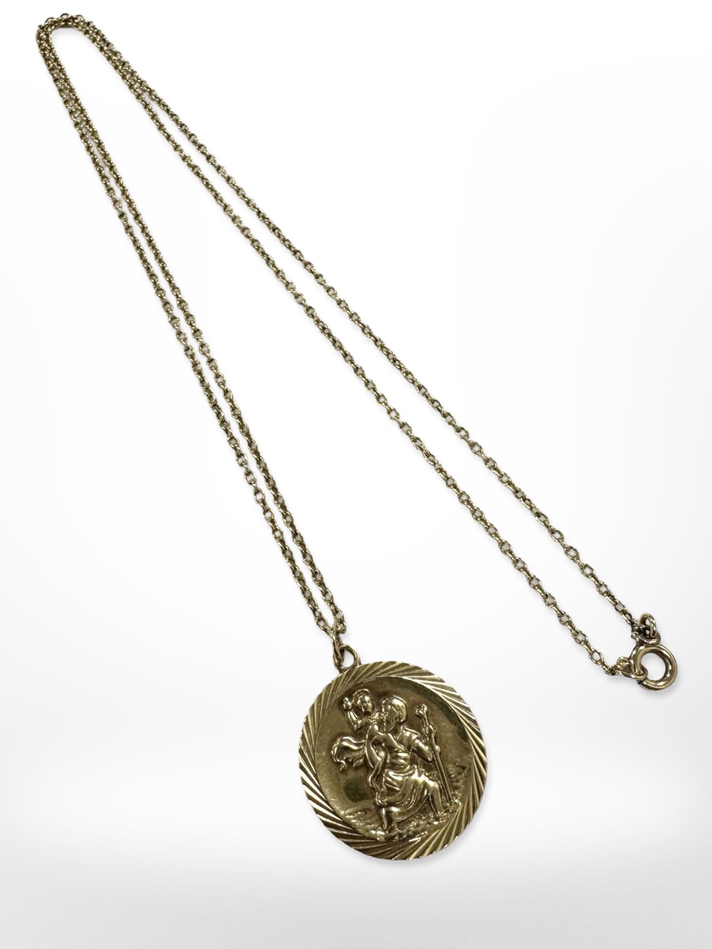 A 9ct yellow gold St Christopher disc pendant on 9ct gold chain CONDITION REPORT: 7.