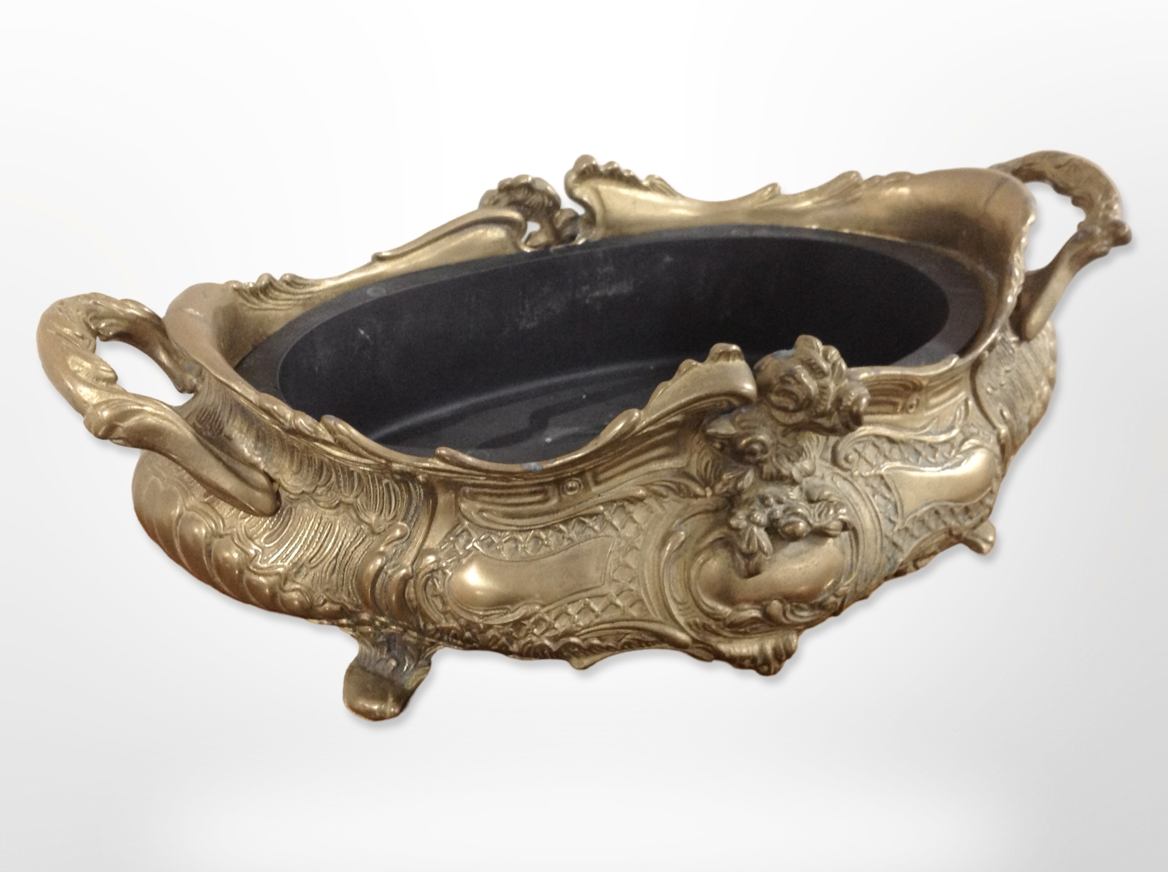 An Art Nouveau style cast brass twin-handled planter with liner,