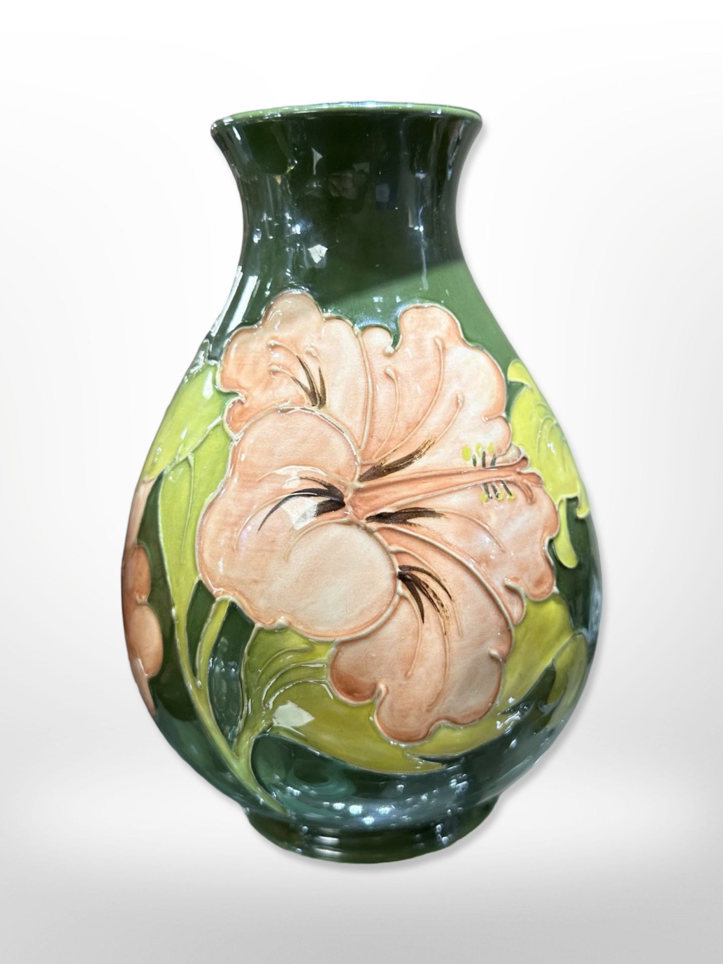 A Moorcroft bulbous vase on green ground, height 20.5cm.
