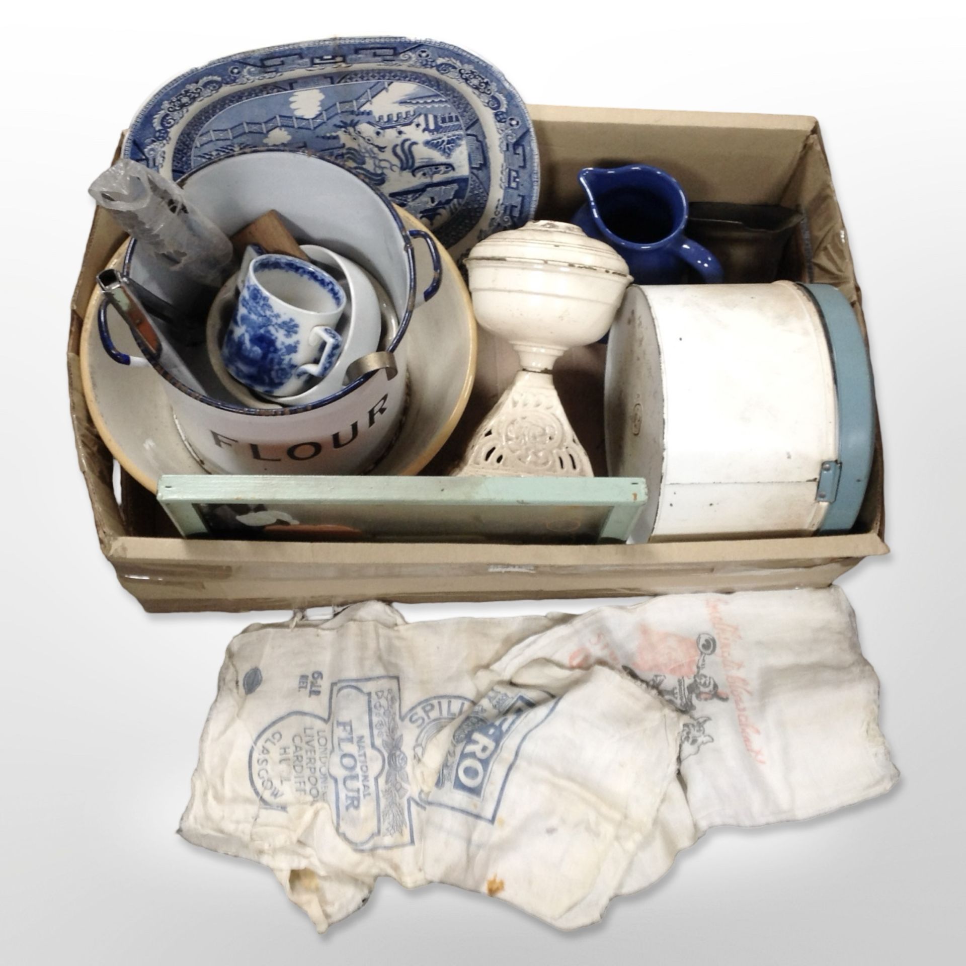 A group of kitchenalia including enamelled flour bin, mixing bowl, willow pattern meat plate,