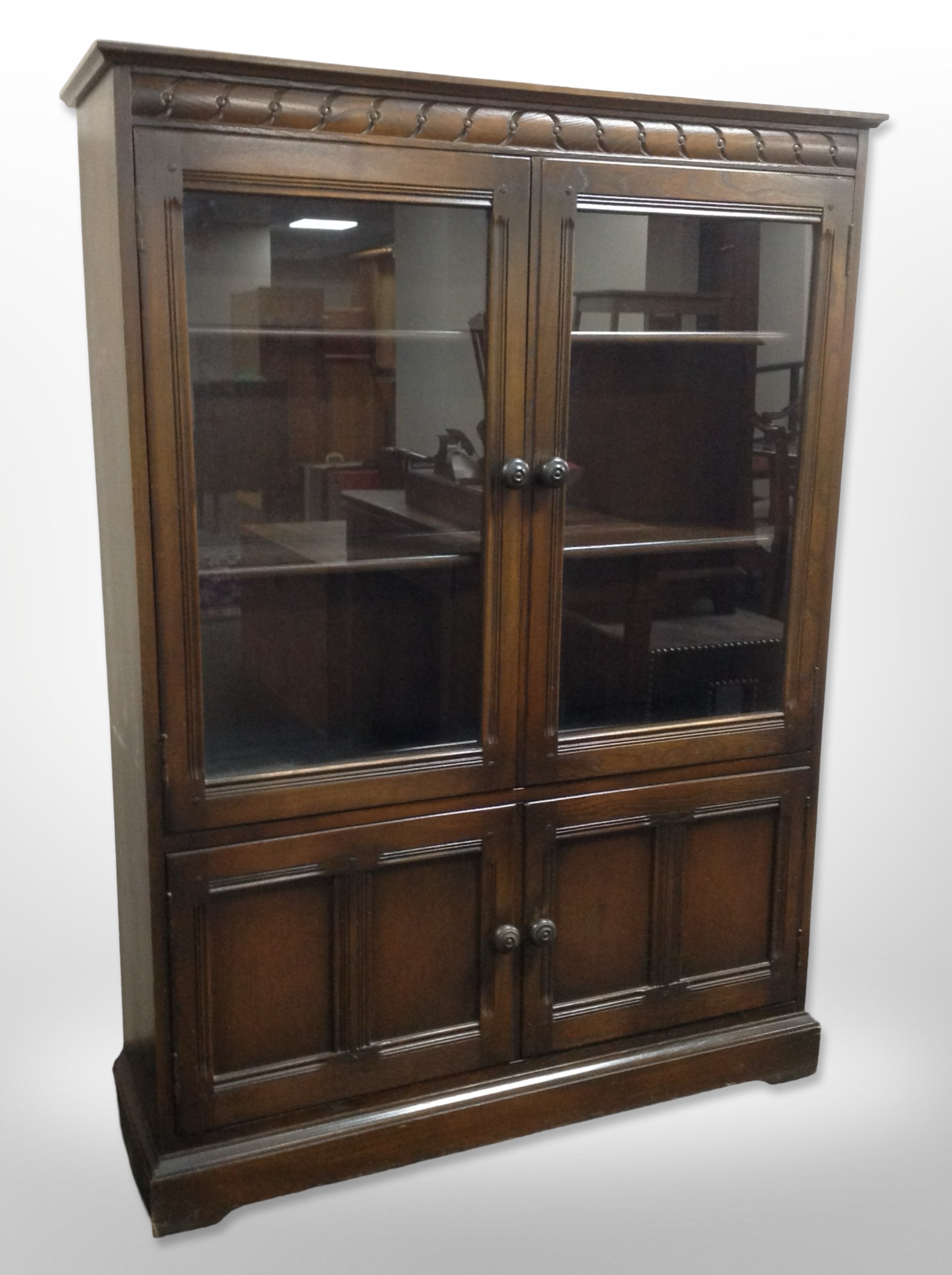 An Ercol stained elm double-door glazed cabinet.