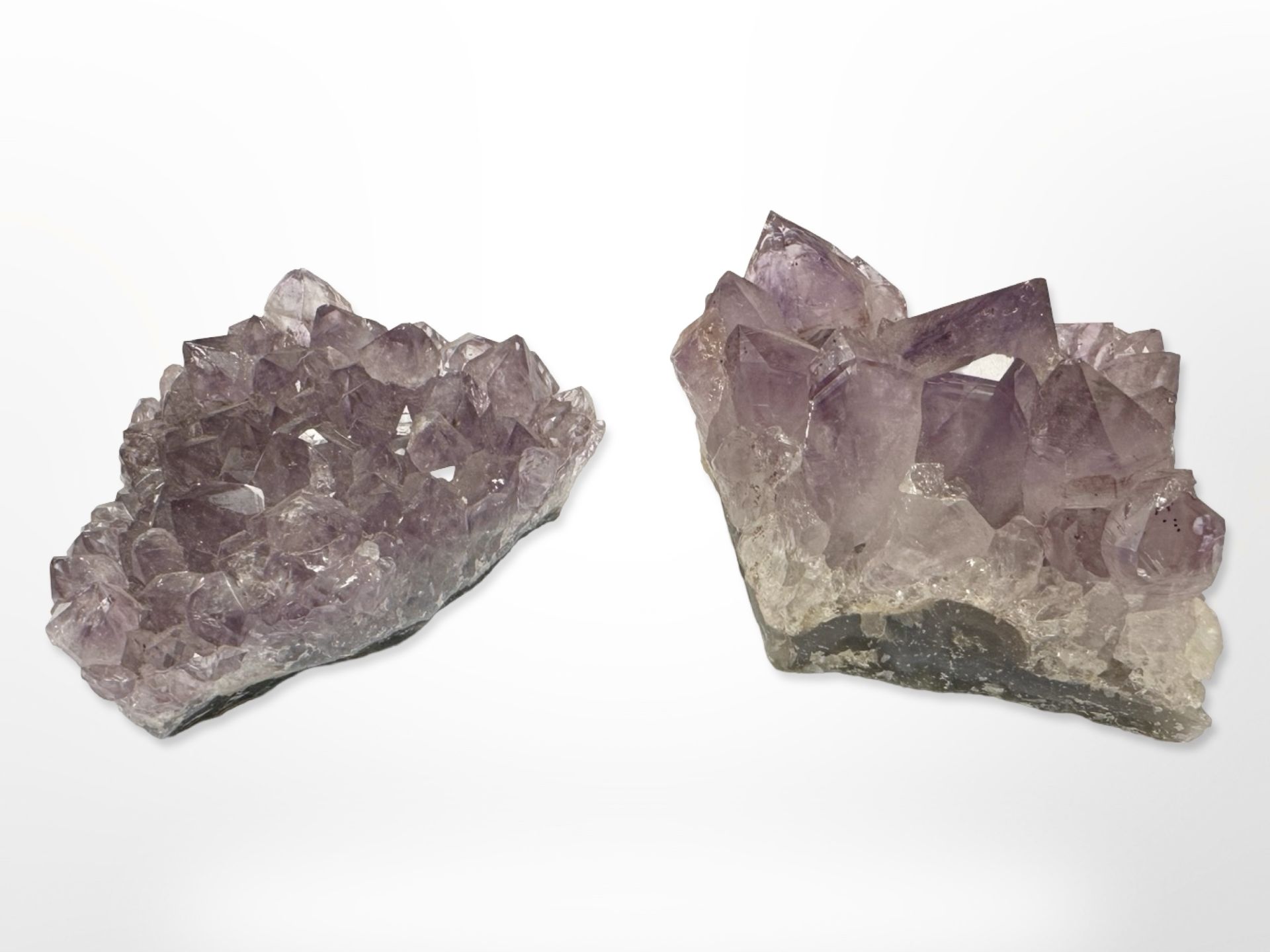 Two pieces of Amethyst rock crystal, each approximately 9 cm x 6 cm.