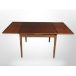 A late 20th century Danish teak pull out extending dining table,
