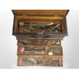 An antique pine joiner's tool box containing assorted carpentry tools