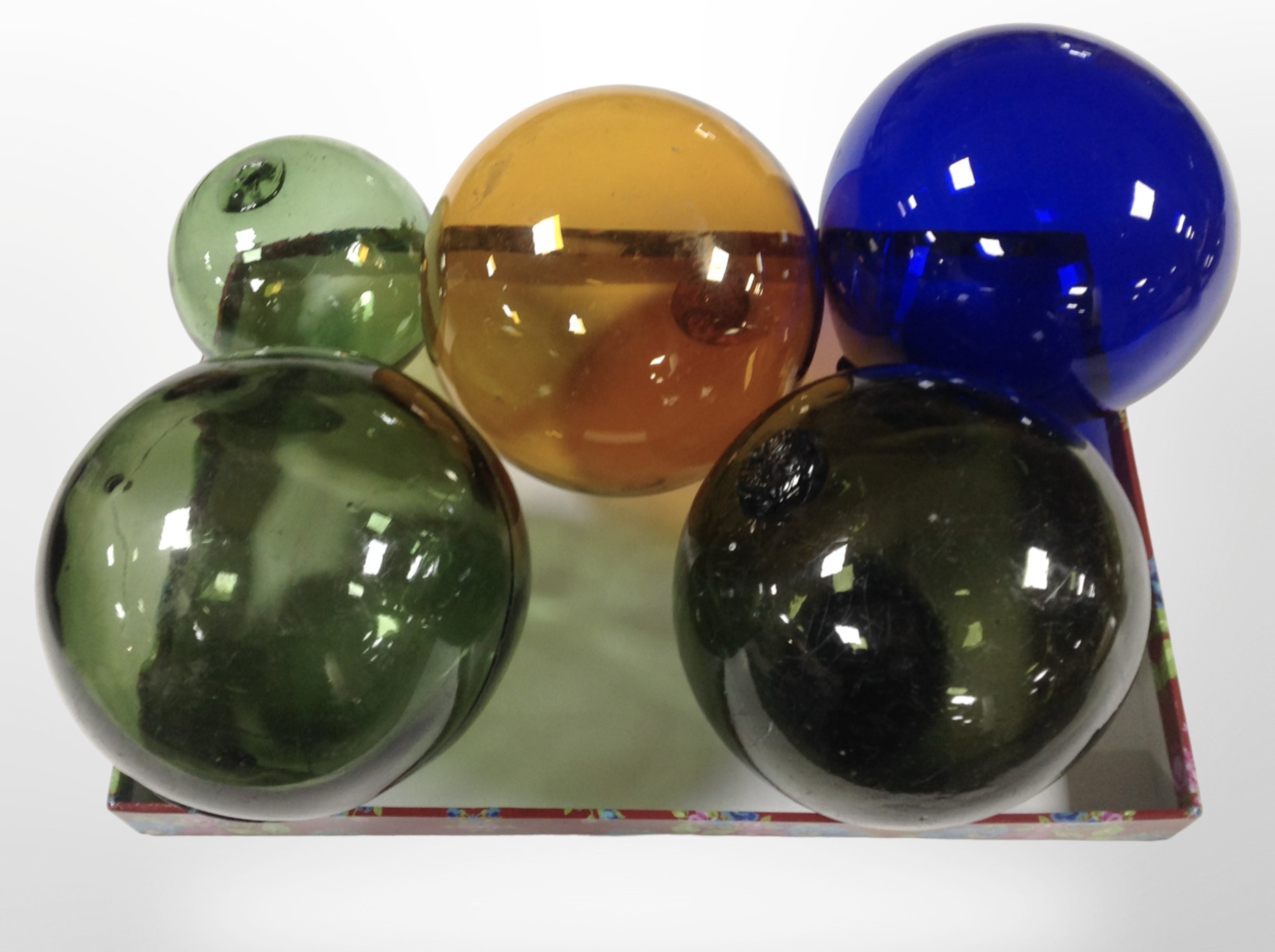 Five vintage glass fishing floats in various colours