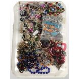 A collection of costume jewellery, glass bead-work pieces, brooches, bangles, etc.