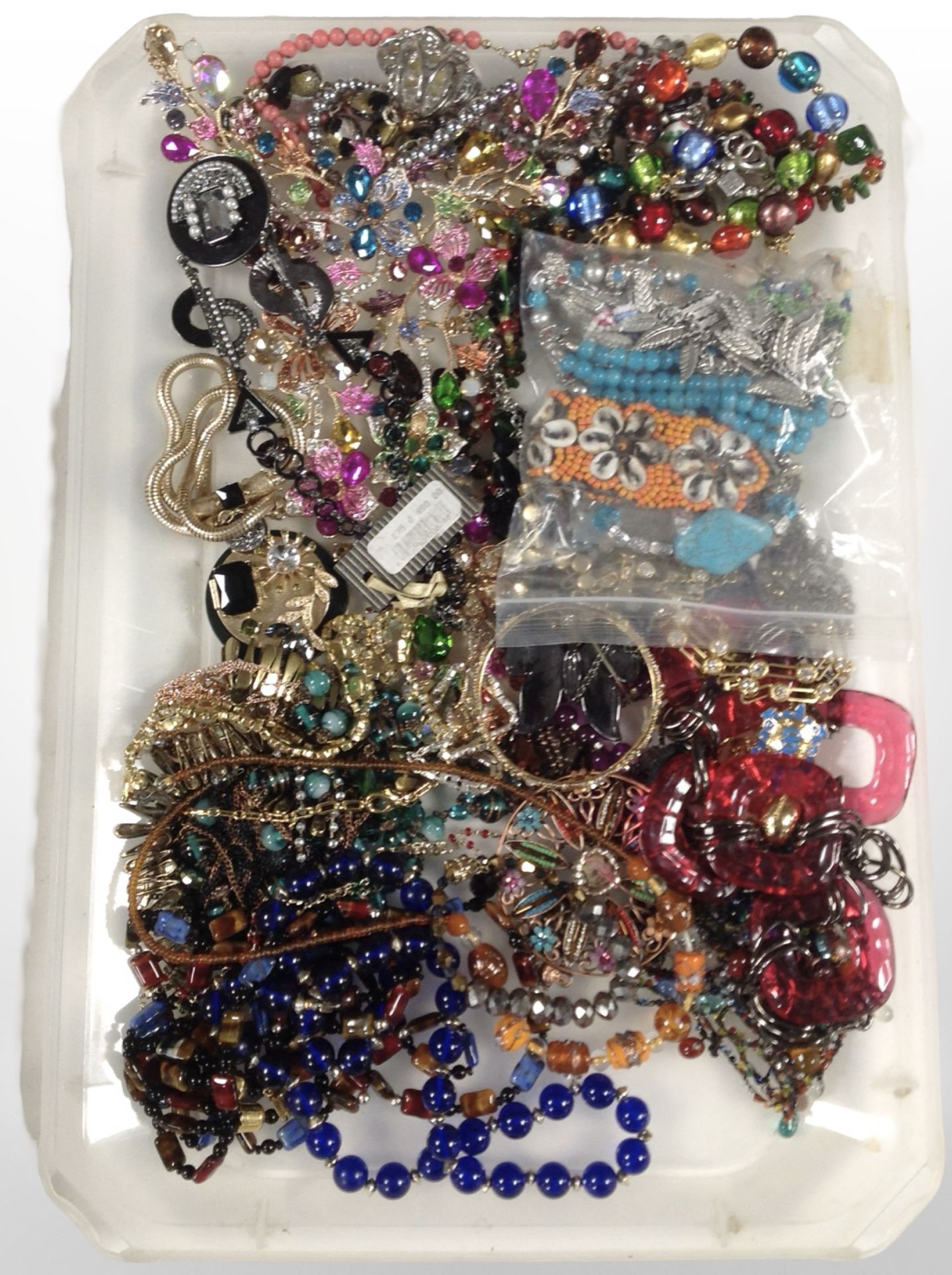 A collection of costume jewellery, glass bead-work pieces, brooches, bangles, etc.