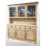 A Danish blond oak dresser with stained leaded glass cabinet doors,