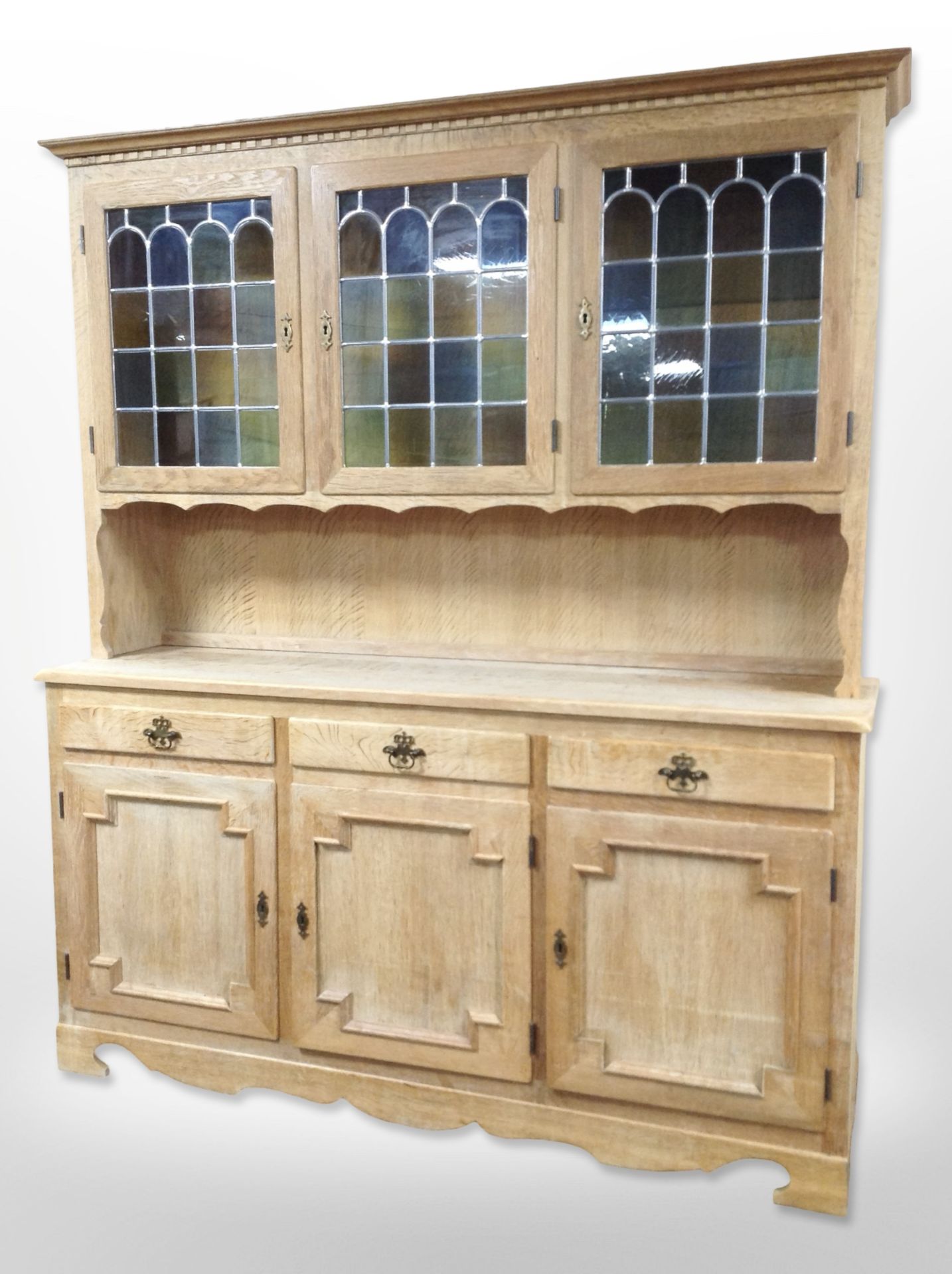 A Danish blond oak dresser with stained leaded glass cabinet doors,