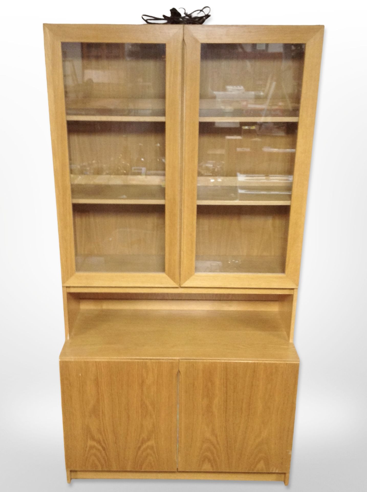 A late 20th century Danish oak veneered glazed bookcase with cupboards beneath,