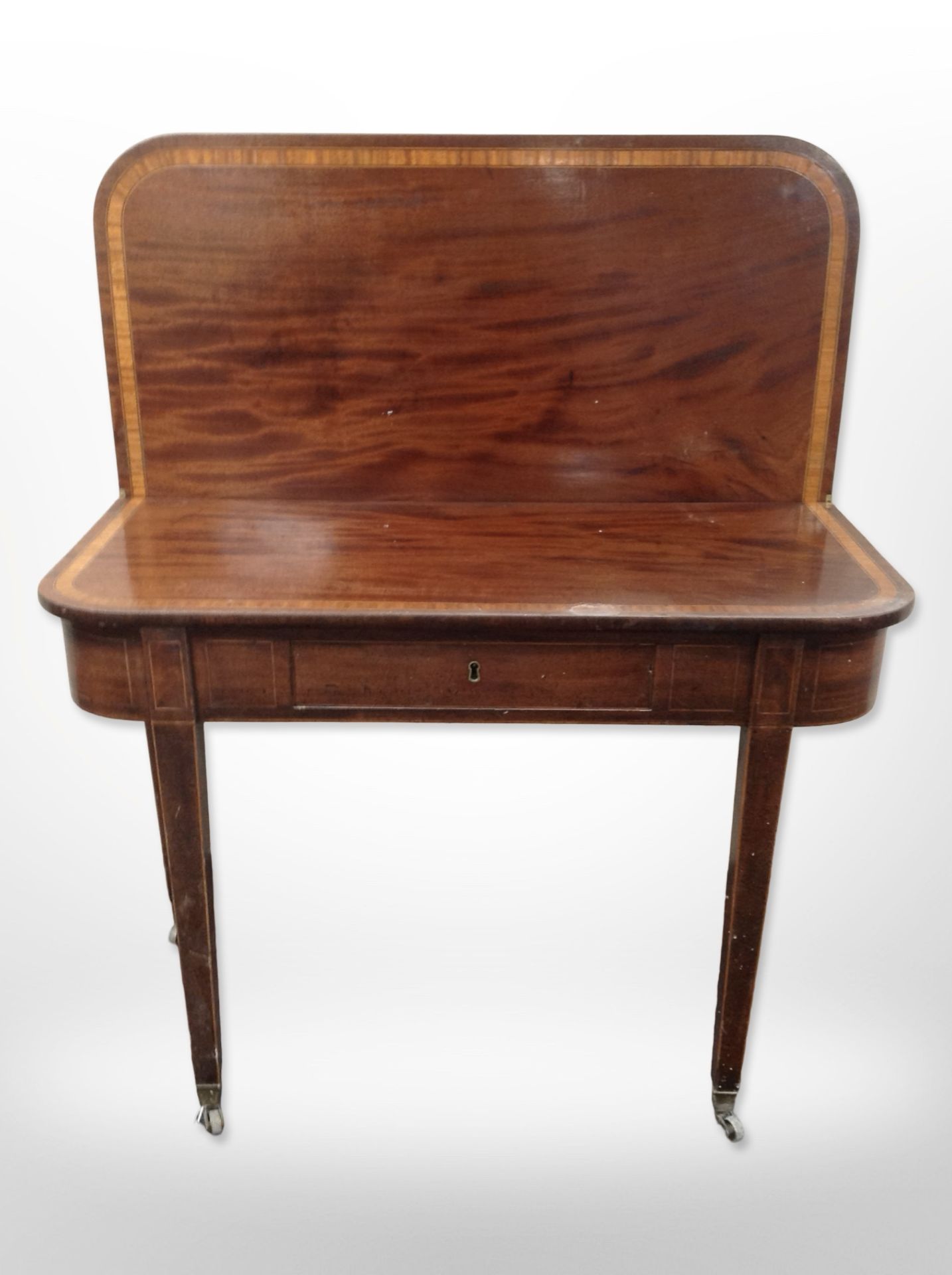 An early 19th century mahogany and satinwood banded turn over top tea table,