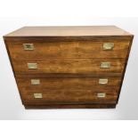 A late 20th century Danish teak campaign style four drawer chest with brass drop handles,