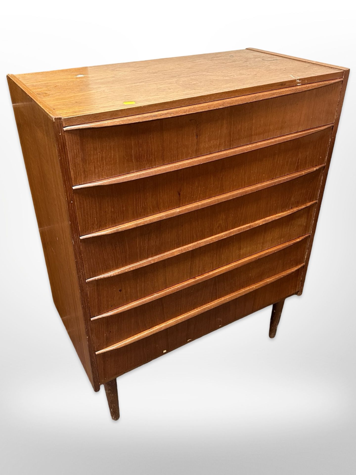 A 20th century Danish teak and pine six drawer chest on tapered legs,