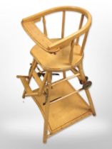 A mid-20th century child's adjustable highchair.