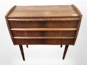 A 20th-century Danish rosewood-effect three-drawer chest on tapered legs,