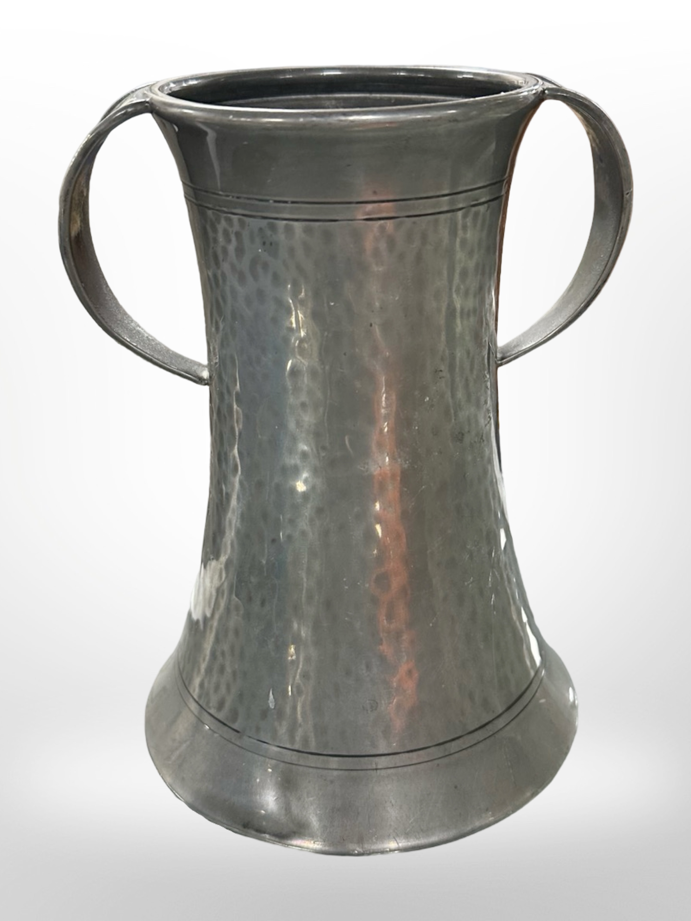An Arts and Crafts hammered pewter loving cup,