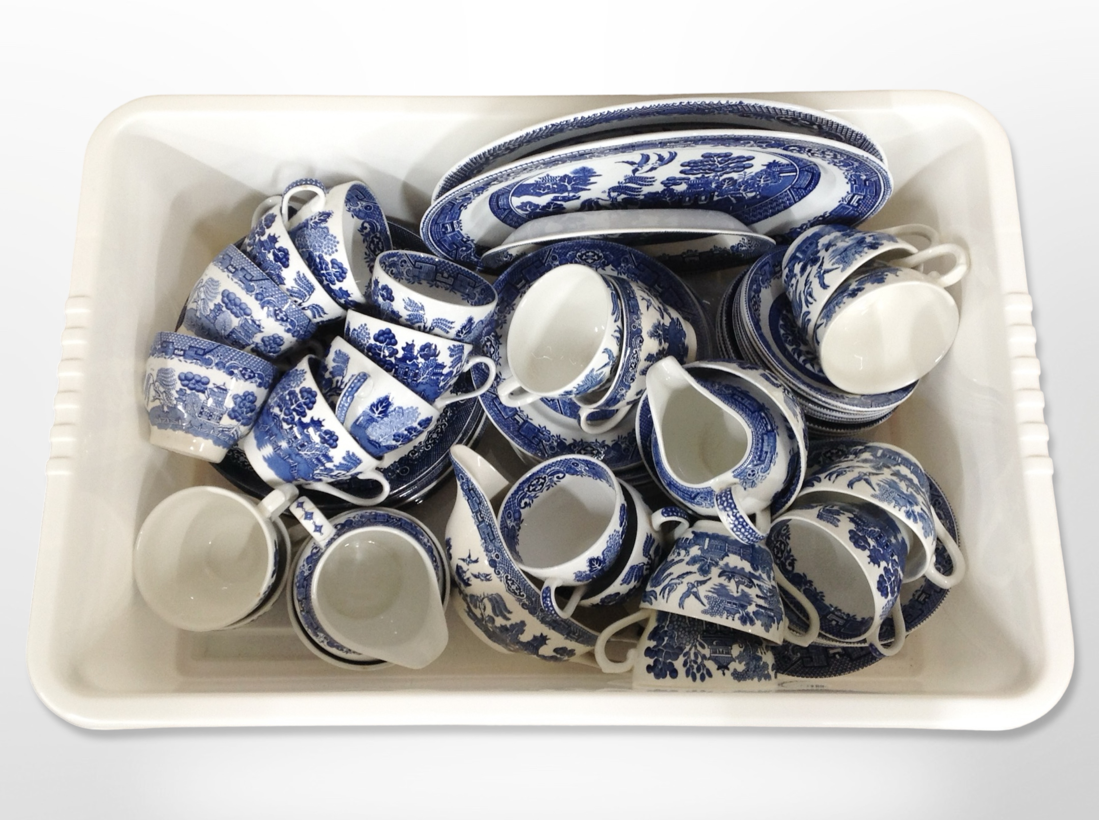 A quantity of Staffordshire Willow Pattern blue and white tea and dinner wares.