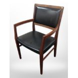 A 20th-century Danish teak and black vinyl armchair.