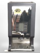 A commercial coffee machine with key and lead.