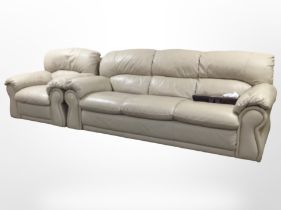 A contemporary three-seater settee and matching armchair, upholstered in stitched beige leather,