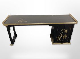 An oriental lacquered and gilt low table, 99cm wide x 30cm deep, 39cm high.