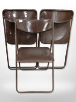 Three 20th-century metal-framed folding chairs.