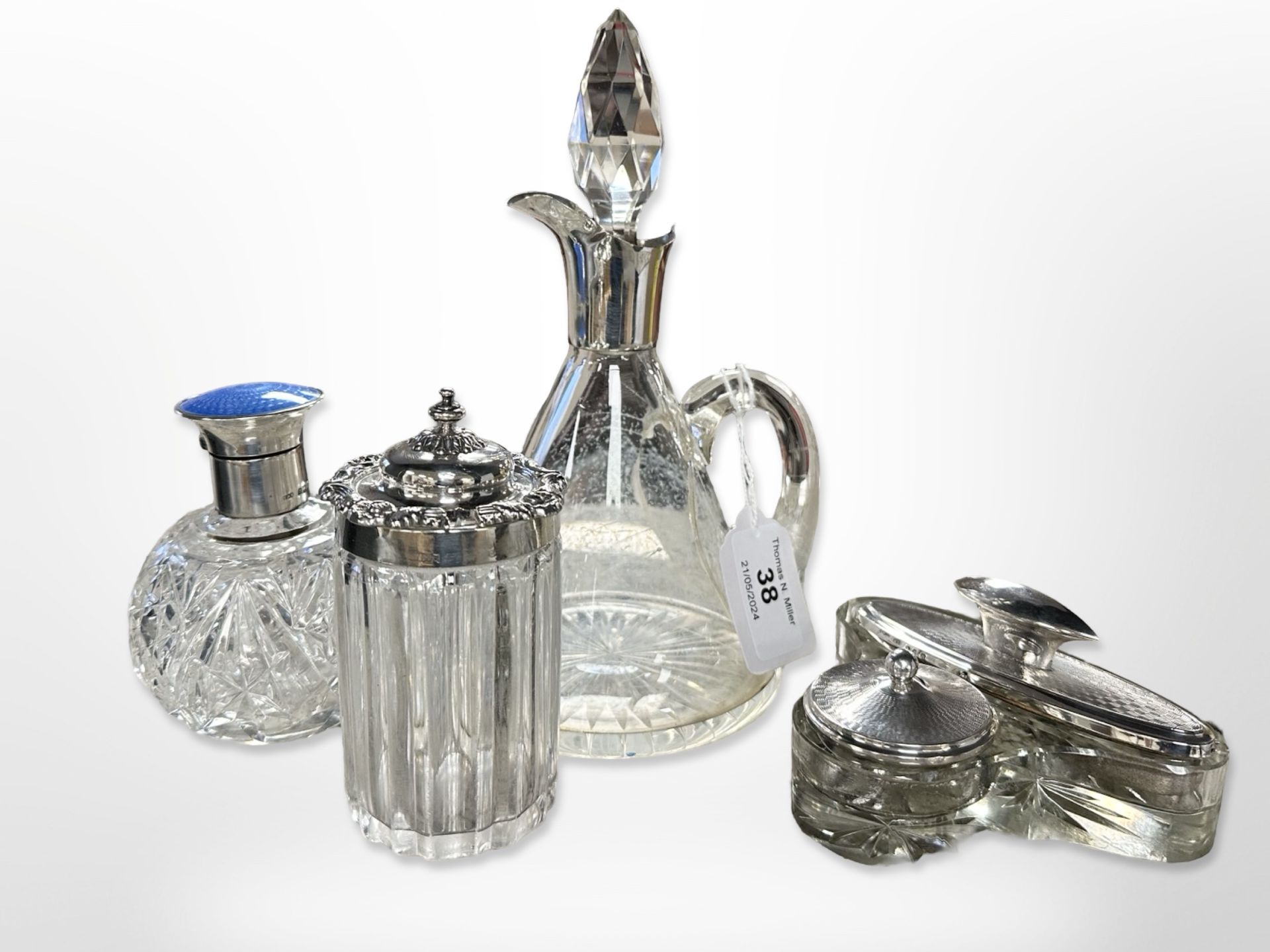 A cut crystal dressing table flask with silver and enamel top, further crystal jar with silver lid,