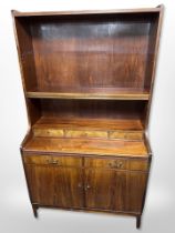 A Danish stained teak and pine open bookcase, fitted cupboards beneath,