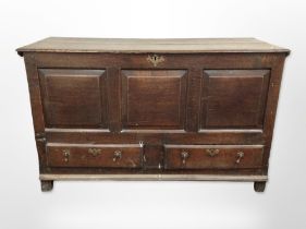 A George III panelled oak mule chest, 150cm wide x 59cm deep x 91cm high.