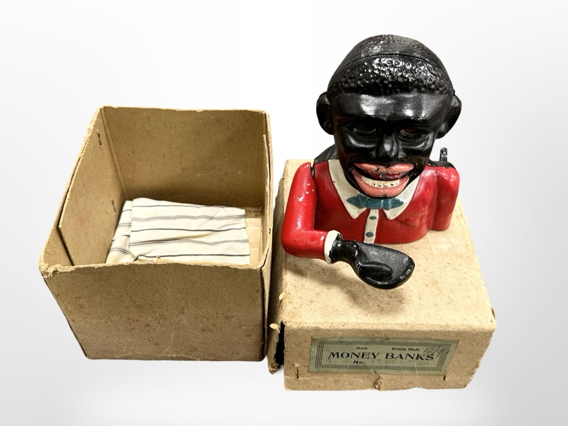 A cast iron money bank with original card box