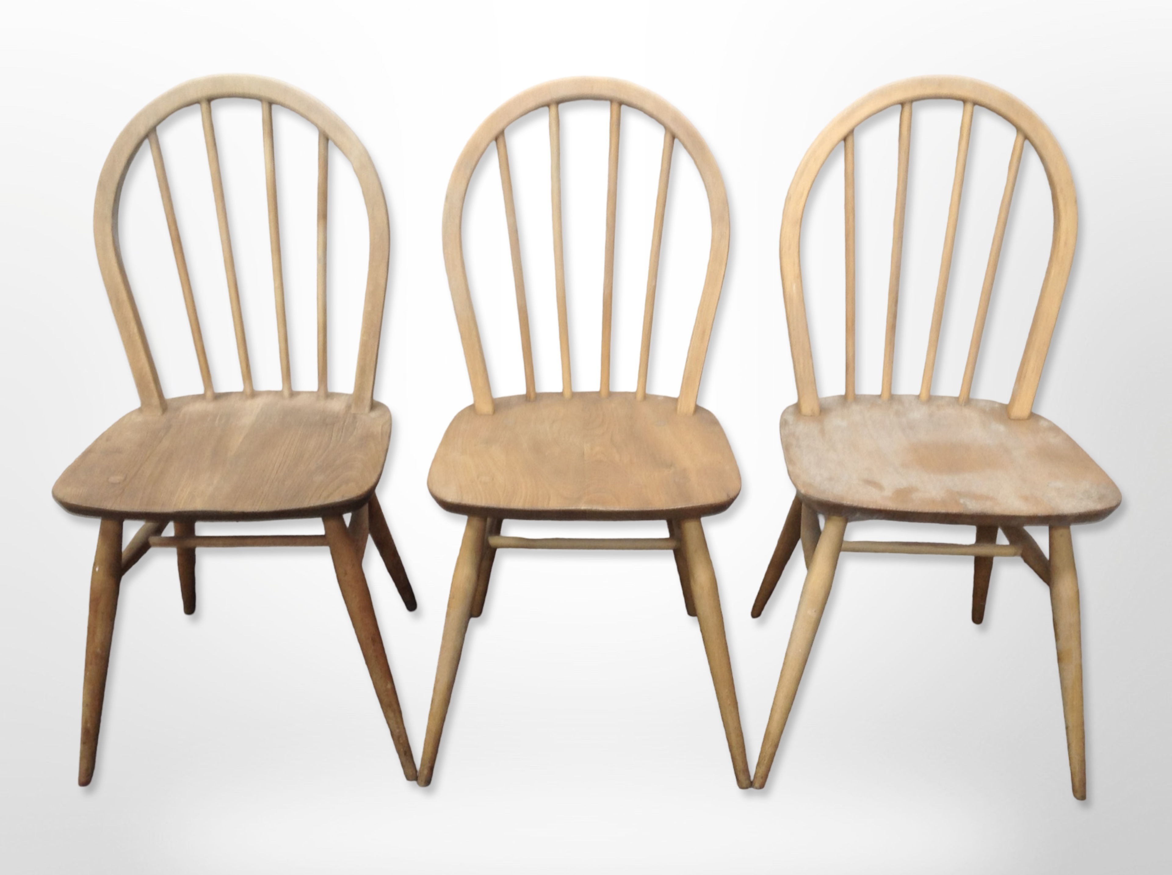 A set of six Ercol stained elm and beech spindle back dining chairs.