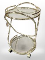 A contemporary brass-framed two-tier circular trolley with mirrored top, height 70cm.