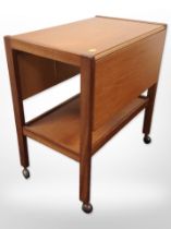 A 20th-century teak and ply drop-leaf trolley on castors,