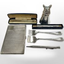 An antique silver plated cigarette case together with fox stirrup cup, cutlery items,