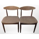 A pair of 20th-century G Plan teak-framed dining chairs in dark brown upholstery.