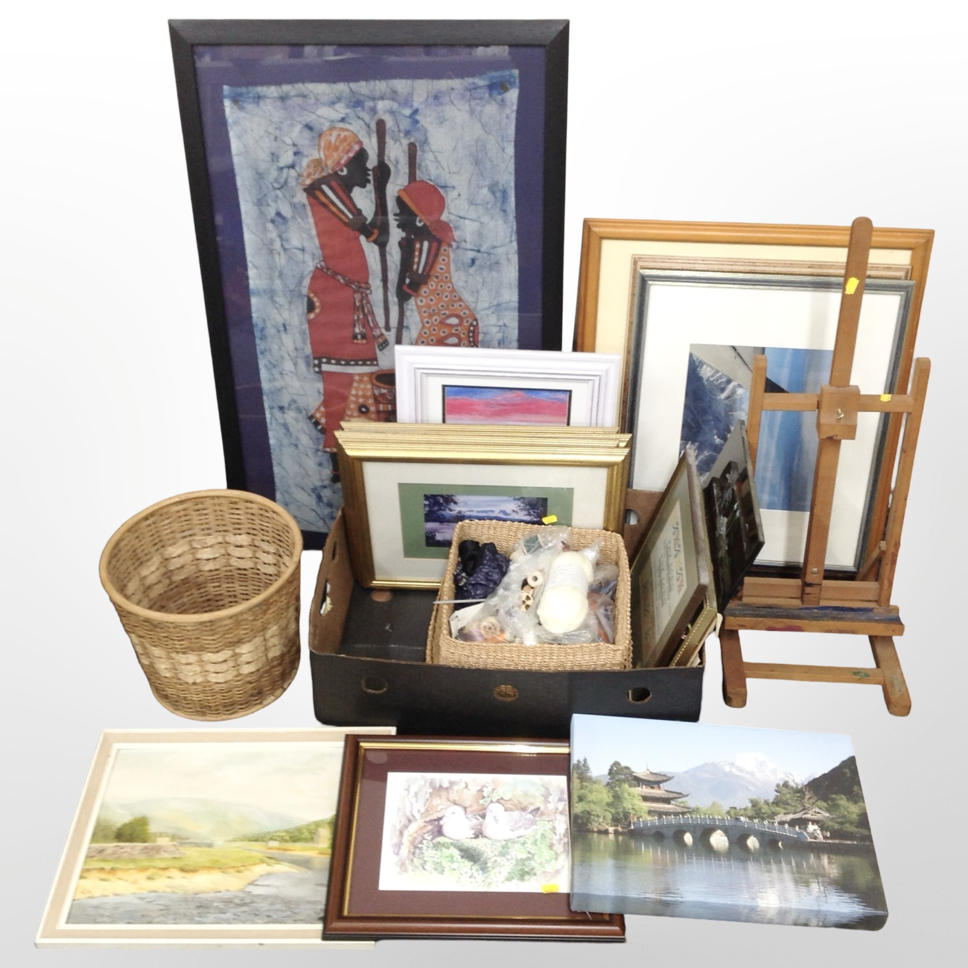 A group of contemporary pictures and prints, wicker items, small adjustable easel,