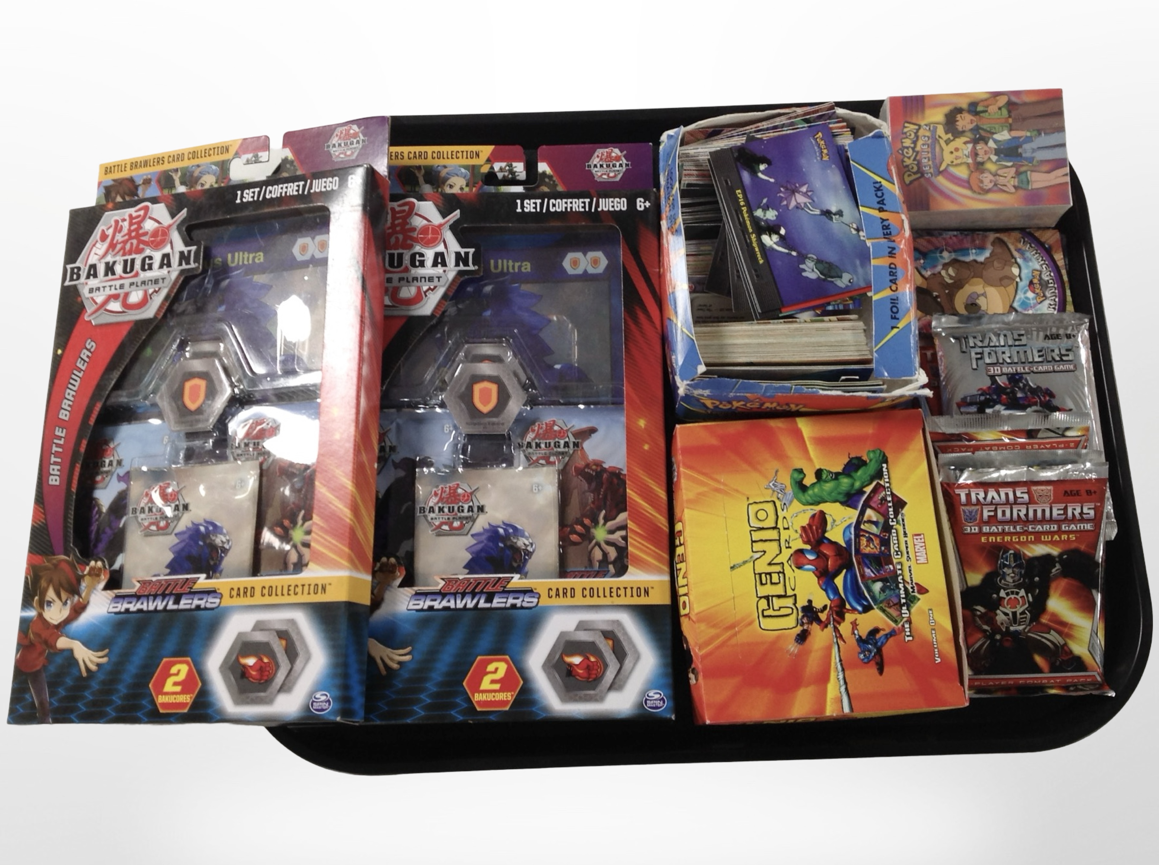 A group of trading cards to include Pokémon, Transformers, Genio, etc.